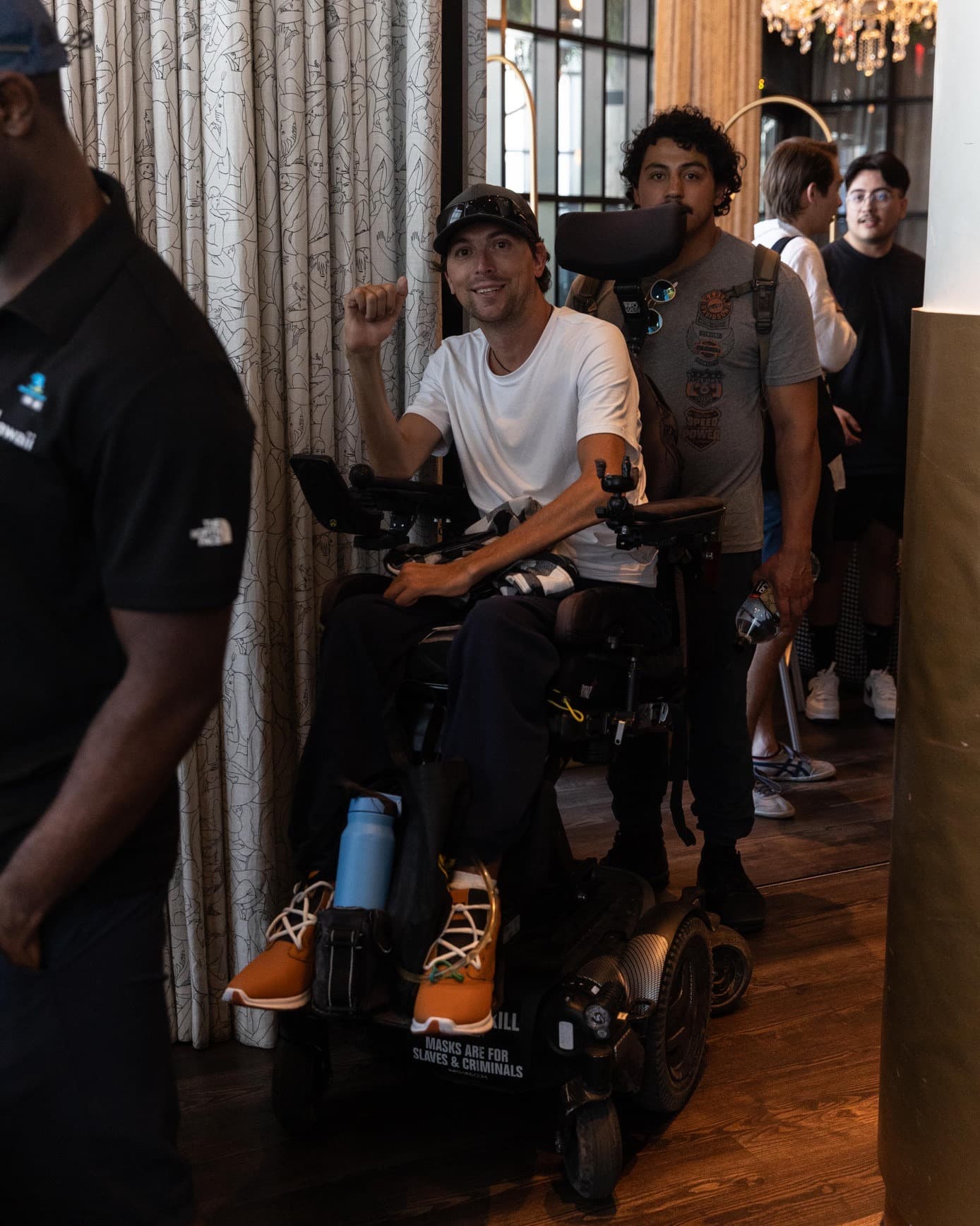Crash (CrashMetaX) in a hotel lobby giving a thumbs up