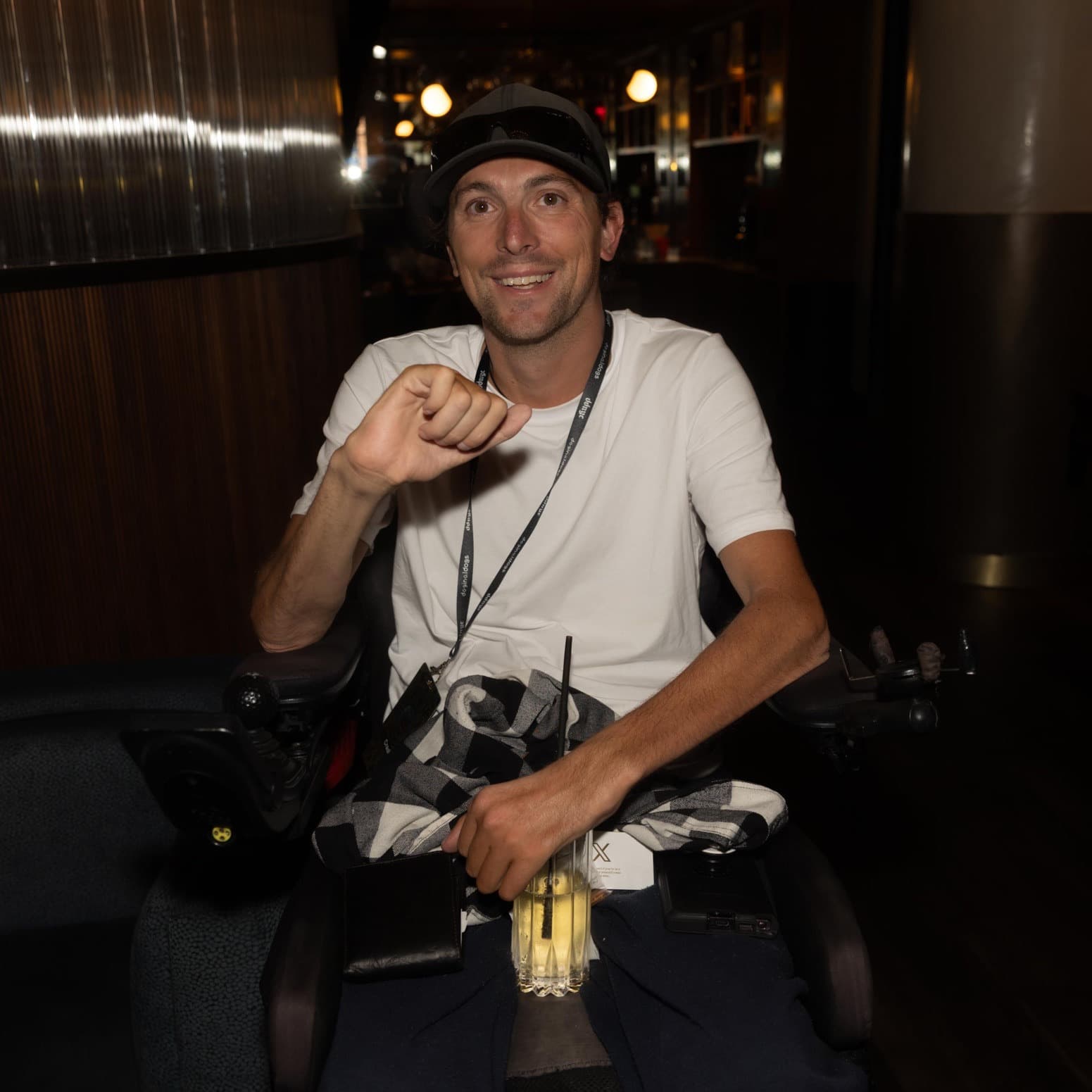 Portrait of Brandon Simmons, publicly known as Crash (@CrashMetaX), smiling in a gray cap and white t-shirt